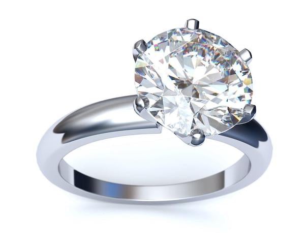 A platinum engagement ring with a very large diamond.